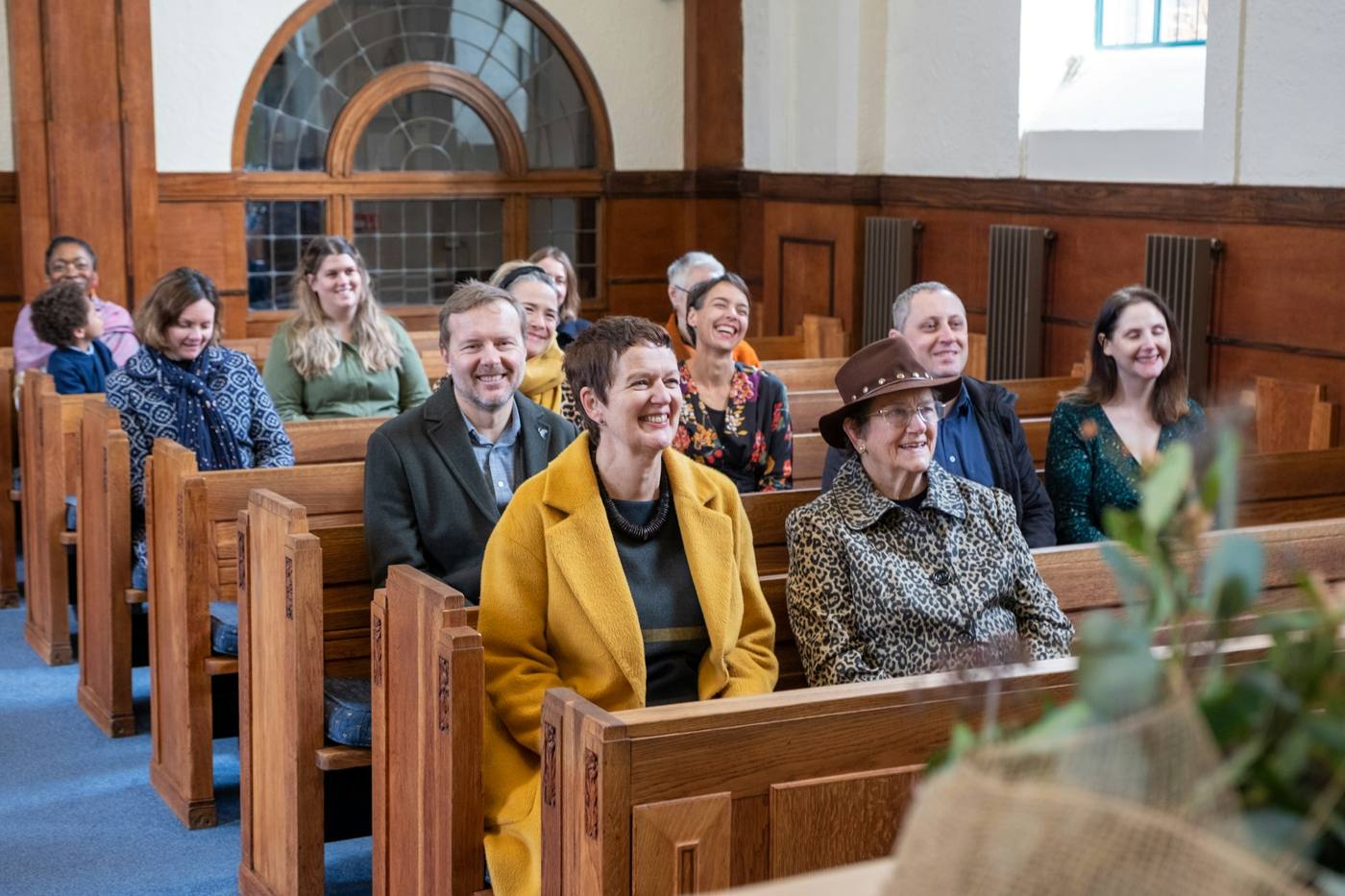A small church congregation seated in the pews