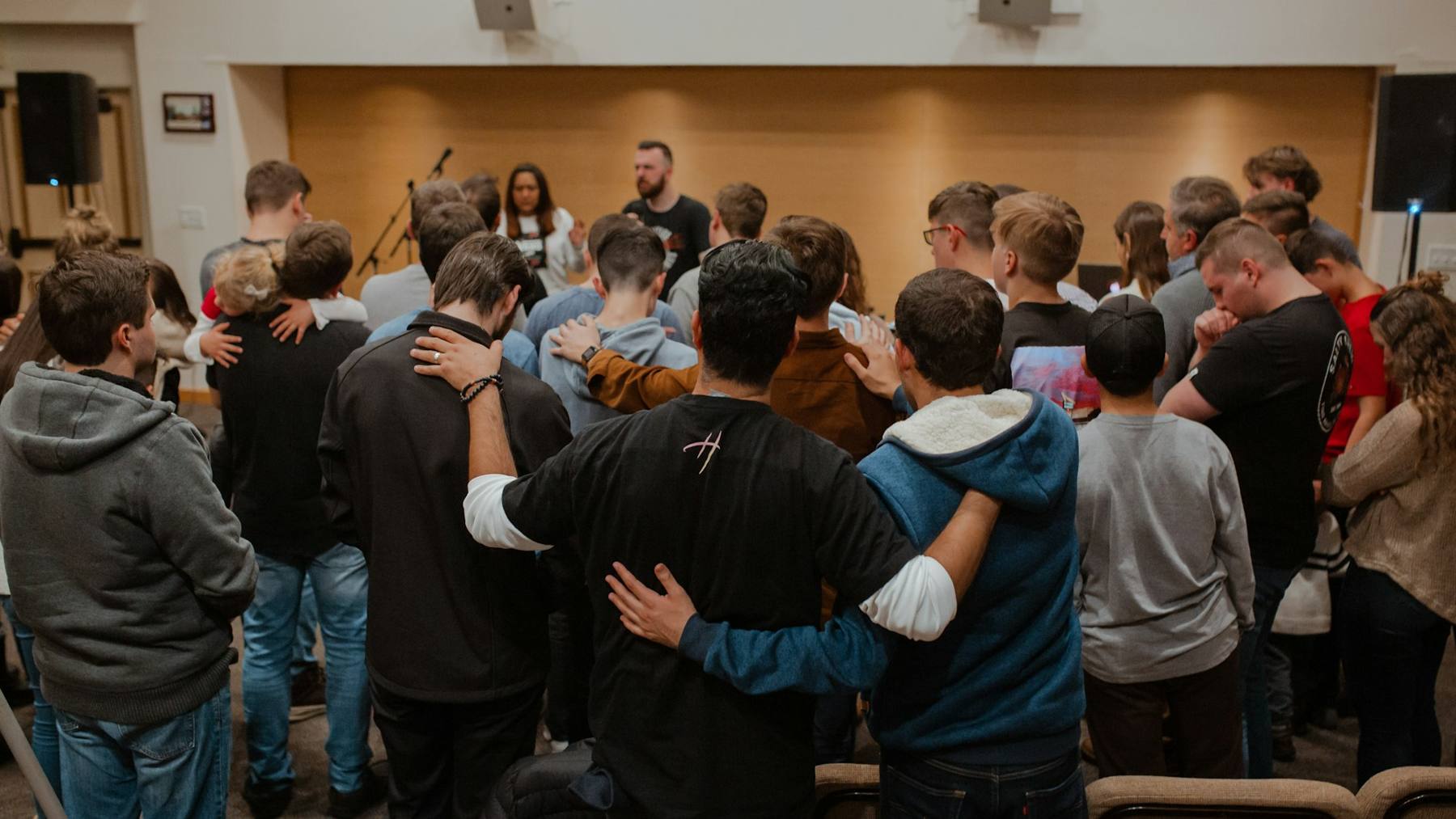 A church congregation standing together in prayer